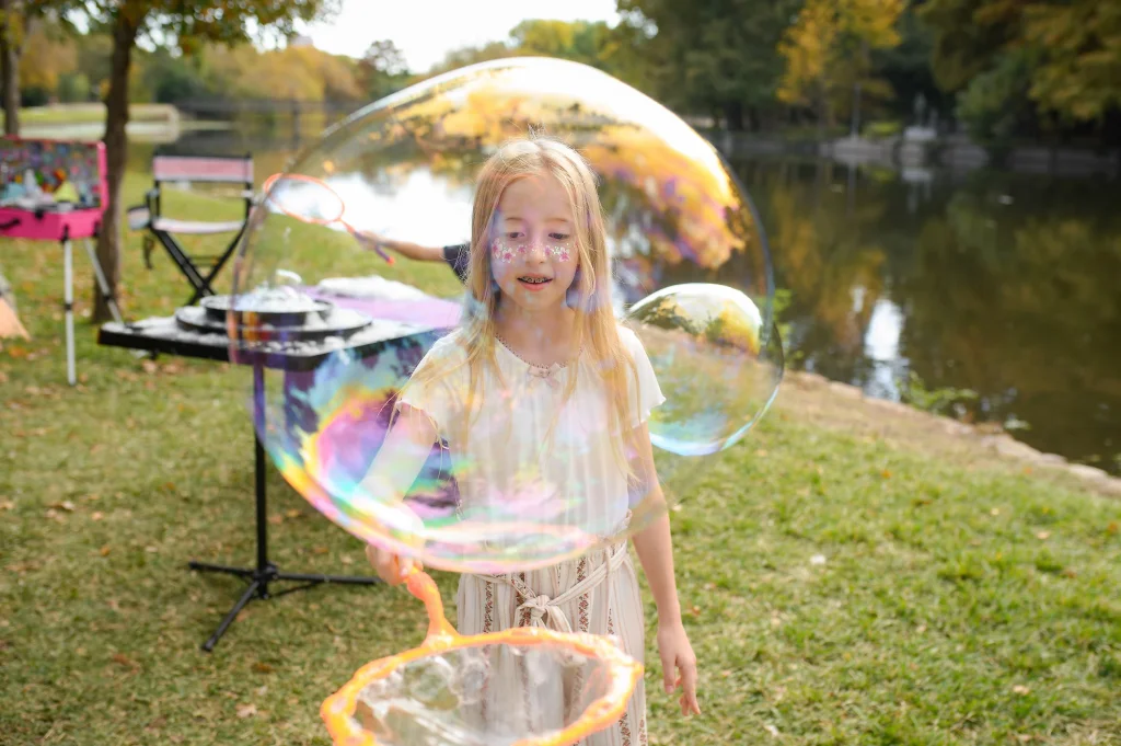 A bubble performer sharing an interactive moment with children
